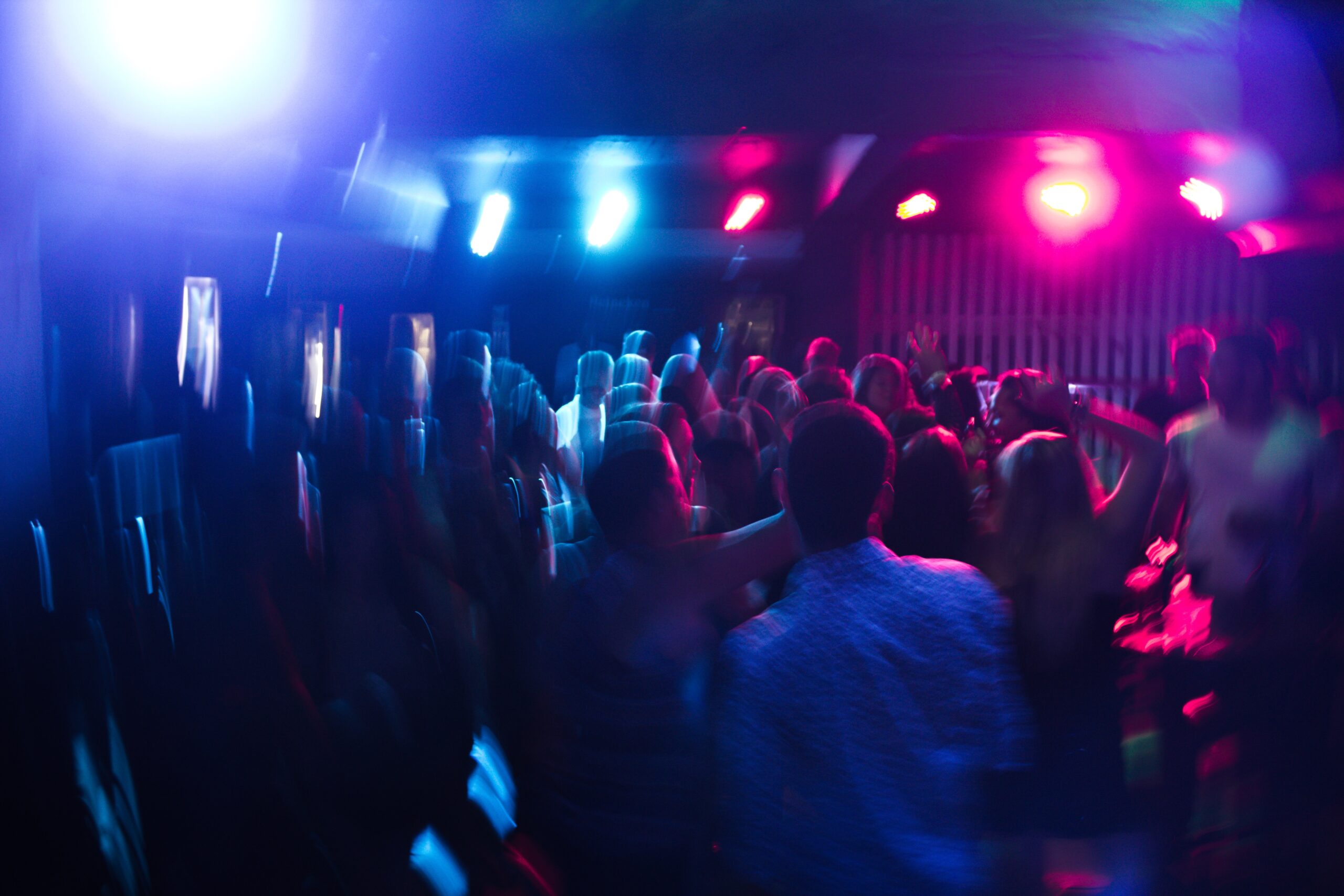 A blurry picture of a dance floor in a club.